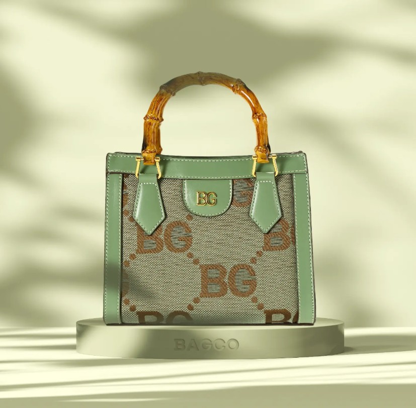 BAGCO Bamboo Handle Satchel with sage green trim and monogram canvas body
